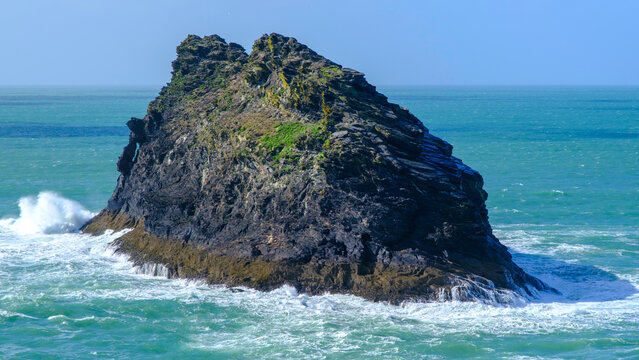 Island of the Cornish coast in dramatic sky and sea