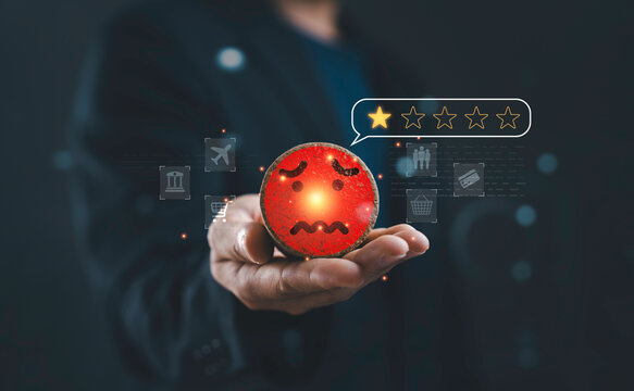 Unhappy customer feedback with low star rating and negative review concept. Businessman holding dissatisfied emotion icon representing poor service quality and customer experience issues.