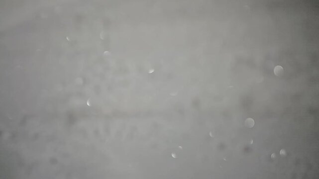 Close-up abstract macro footage featuring a dark frosted surface with subtle sparkling highlights and soft cinematic focus. Ideal for background overlays, moody edits, sci-fi visuals, title sequences,