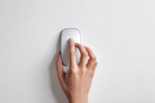 Hand using computer mouse on white surface