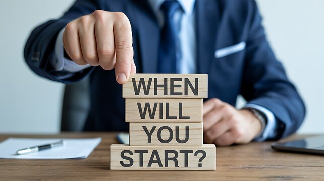 Corporate professional presenting wooden blocks with an urgent call to action When Will You Start