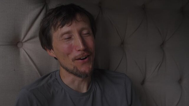 Middle aged man laughing while looking at something, high quality uncompressed audio recording. Genuine positive emotion captured in real time. Joy, humor and everyday lifestyle concept.