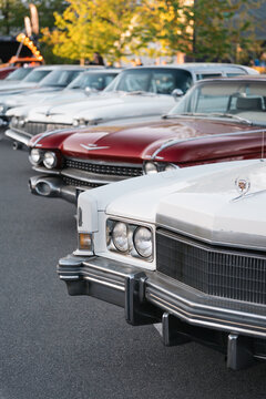 Four Cadillac Eldorados of different generations. Horizontal image of 1960s-1970s GM cars in parking lot at golden hour - local car meet. Kyiv, Ukraine - May 16 2026
