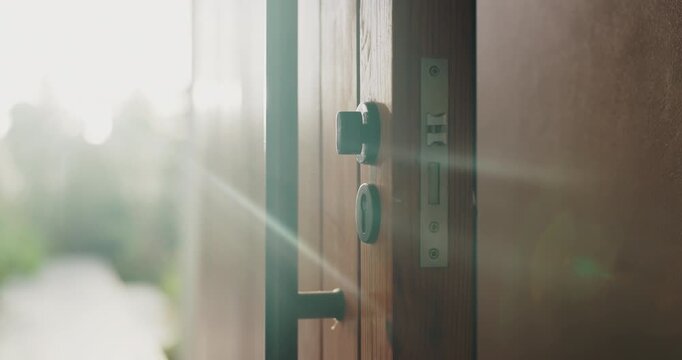 Entrance, security and sunlight in home for real estate or residential property ownership in summer. Handle, lock and wooden door of modern apartment with accommodation, flare or housing feature