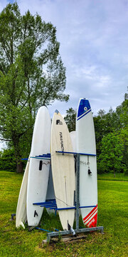 Sulzberg, Bavaria, Germany - May 25, 2024. A rack with several rigid SUP boards for stand-up paddle boarding from the Riverday, model SUP-n-GO.