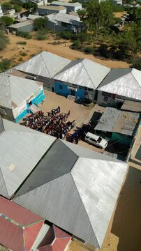 High altitude drone shot displaying the wide footprint of a newly built community center and school facility constructed for poor orphans in a low income Somali neighborhood