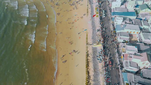 Aerial flyover: Crowds following festival parade on Phuoc Hai seawall