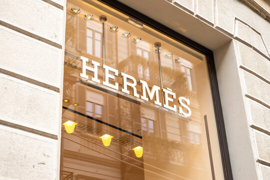 Herm&egrave;s Luxury Boutique Storefront Sign Reflected in Window With Warm Interior Lights  Milan Italy May 14, 2026