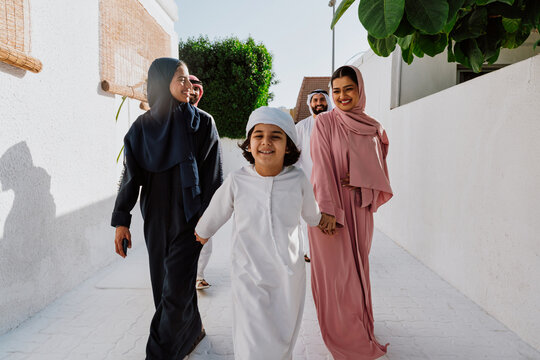 Emirati family standing together and smiling outdoors