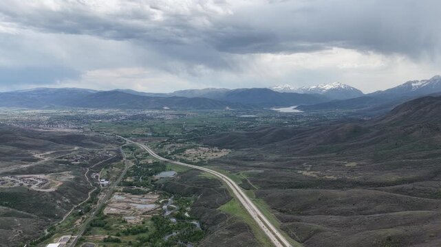 Wide high aerial of Wasatch Range and Highway 189 near Park City Utah in spring