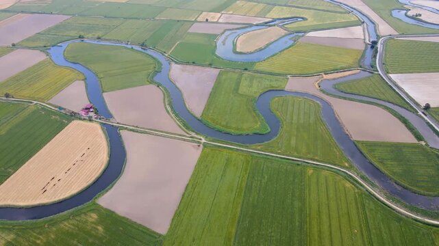 Large agricultural areas containing cotton, corn, and sunflower fields. The footage of the meanders flowing through these agricultural lands.