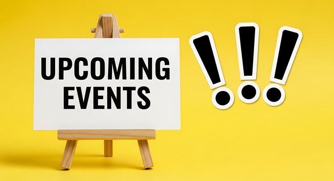 Upcoming events text on white board, wooden easel stand on yellow background, announcement and schedule concept with exclamation marks