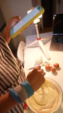 An inviting scene where hands mix batter in cozy kitchen environment