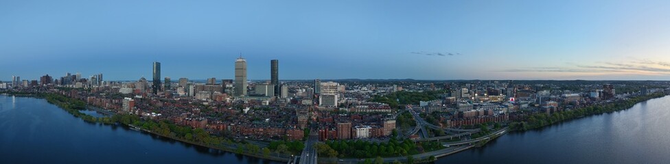 Obraz premium Panoramic aerial view of Boston skyline and Charles River at sunset, USA featuring the Prudential and John Hancock towers above historic Back Bay and the calm Charles River
