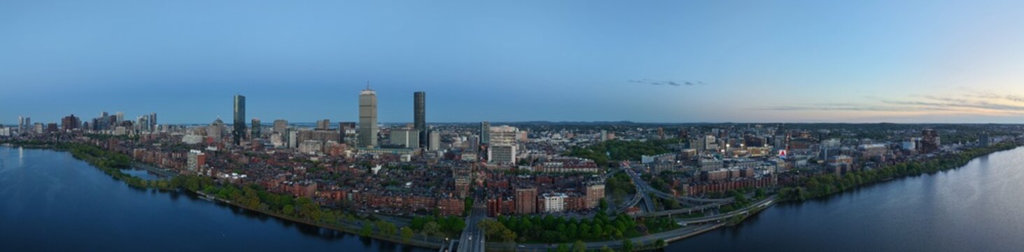 Panoramic aerial view of Boston skyline and Charles River at sunset, USA featuring the Prudential and John Hancock towers above historic Back Bay and the calm Charles River
