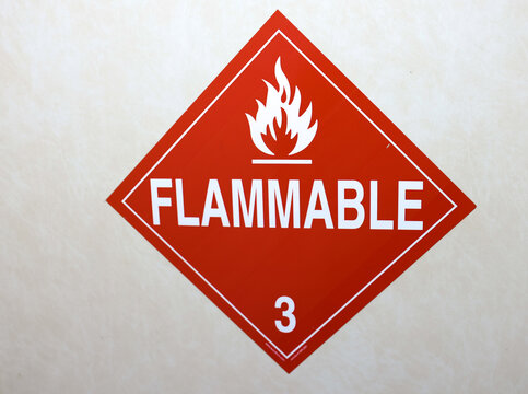 Flammable Hazard Warning Sign on Industrial Container &ndash; Red Safety Label for Dangerous Materials