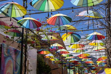 Naklejka premium a street in Puerto Plata decorated with colorful umbrellas, Dominican Republic