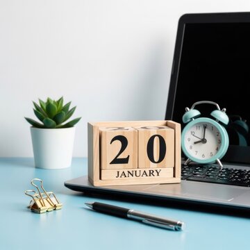 Workspace with calendar, laptop, and plant