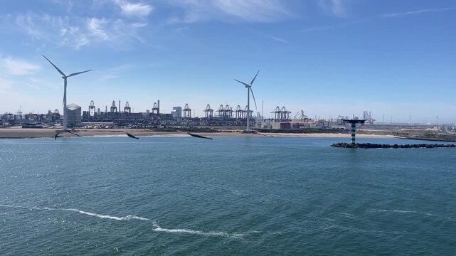 Close-up of windmill blades over the harbor