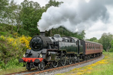 Naklejka premium Steam Train, North Yorkshire Moors Railway in Yorkshire, England, UK, steam train travelling through scenic moorland countryside on the historic heritage railway line.