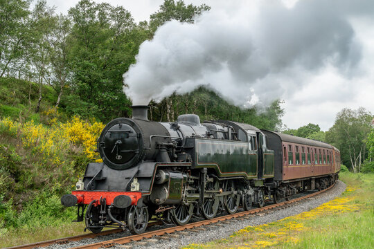 Steam Train, North Yorkshire Moors Railway in Yorkshire, England, UK, steam train travelling through scenic moorland countryside on the historic heritage railway line.