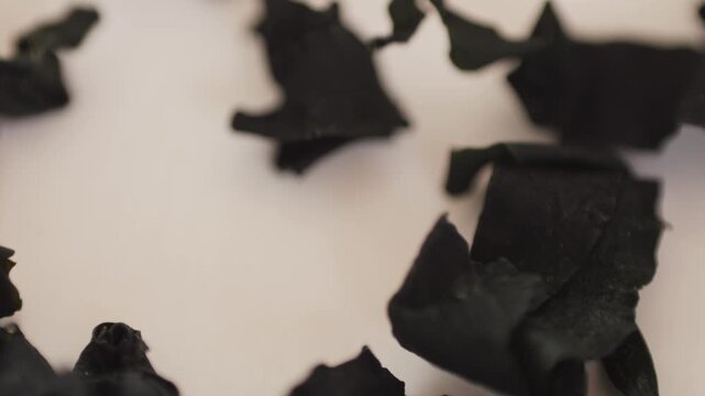 Dried wakame seaweed on a kitchen table. Dry laminaria, asian dish close up.