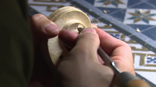 Bilbao, spain; may 21 2022: luthier carving a violin scroll with a chisel