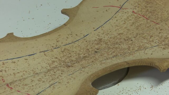 Bilbao, spain; may 21 2022: luthier performing a chladni plate test on a violin backplate