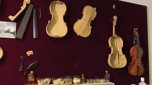 Bilbao, spain; may 21 2022: luthier workshop wall displaying unfinished violins