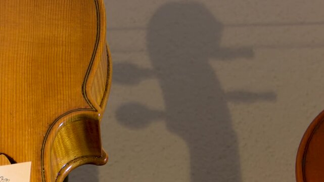 Bilbao, spain; may 21 2022: violin body with scroll shadow in luthier workshop
