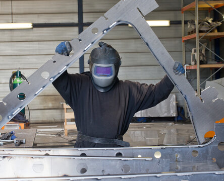 Building the framework of a aluminium hull. At the shipyard building a super sailing yacht. Welding and bending the aluminium parts.