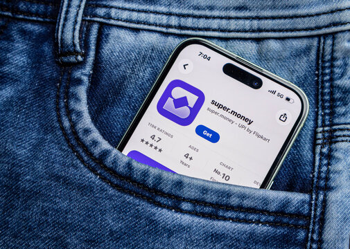 Smartphone in a denim jeans pocket displaying the supermoney app store page on screen, showing the upi payment application by flipkart