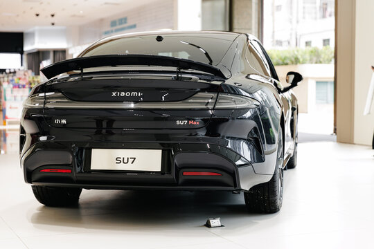 Guangzhou, China - December 22, 2025: black electric crossover xiaomi car SU7 vehicle in showroom