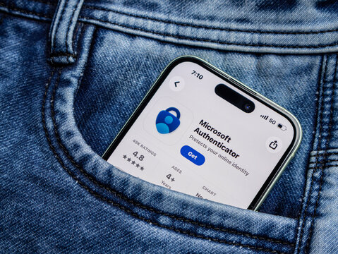 Smartphone showing microsoft authenticator app in a blue denim jeans pocket