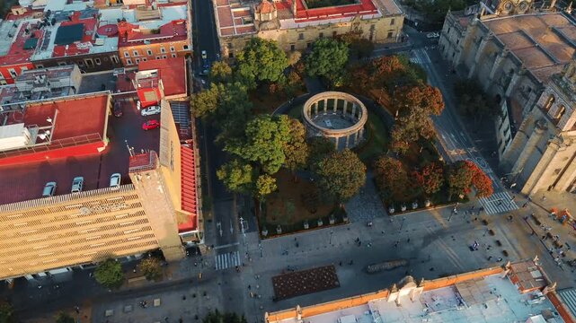 Rotunda of Illustrious Jaliscienses Monument and Guadalajara Cathedral Main Facade Featuring an Aerial Drone Overflight during a Warm Sunset in Jalisco Mexico