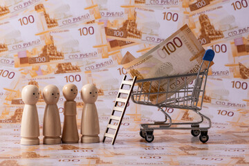 A line of symbolic wooden figures stands against a backdrop of 100-ruble Russian banknotes. © Max Zolotukhin