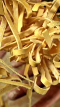 A man throws up homemade pasta. Filmed on a high-speed camera at 1000 fps. High quality FullHD footage