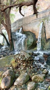 Description (للنسخ مباشرة):
Waterfalls at Wadi Tanuf in Nizwa with flowing water over rocks and trees, showcasing Omani nature and landscape. Nizwa, Oman - June 4 2026