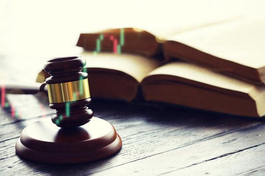 Wooden judge gavel and legal book on wooden table