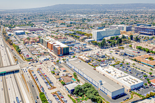 Torrance, California CA August 15, 2024: High Aerial City Drone View toward Harbor UCLA Medical Center around Carson St, Vermont Ave, Normandie Ave, Freeway 110 with Homes, Houses, Streets, Shops