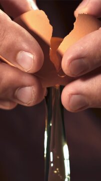 Hands of a man with a falling raw egg. Filmed on a high-speed camera at 1000 fps. High quality FullHD footage
