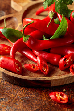 Heap of red hot chili peppers on a kitchen table.