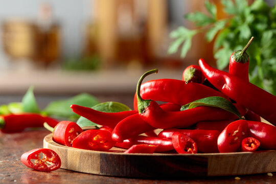 Heap of red hot chili peppers on a kitchen table.
