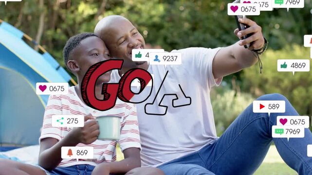 Dad and son posing for selfie, angling phone outward and spawning social media icons around them