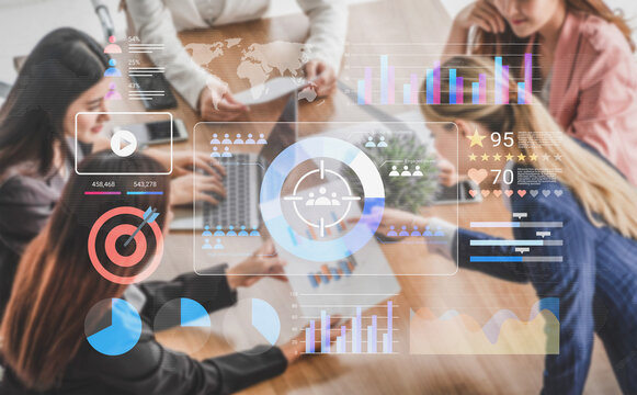 A group of professionals collaborates in a modern office, surrounded by digital analytics and data visualizations, showcasing teamwork and strategic planning. Gantry