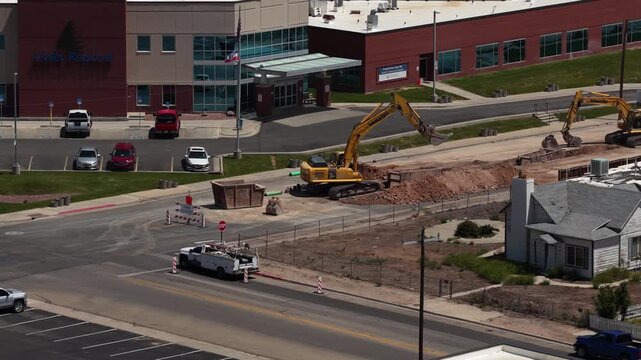 Zoom aerial of construction next to hospital in Vernal Utah small town