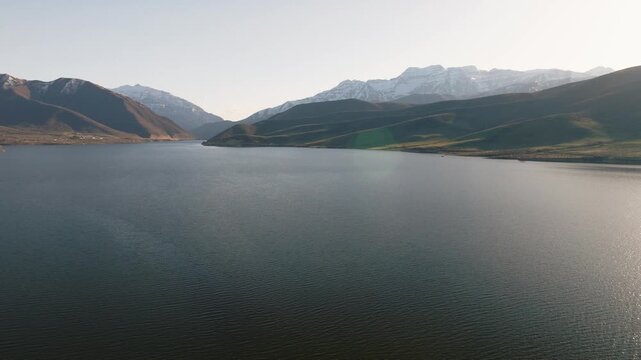 Aerial view of Provo Canyon with calm water and snow-capped mountains under a clear sky Orem, Utah, United States.
