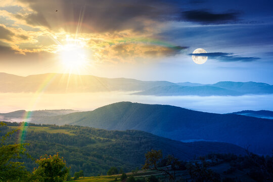 day meet night. foggy carpathian countryside on summer solstice. view of mountainous landscape with rural fields on rolling hills. sun and moon over fog in the valley. clouds above the mountain