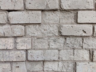 Fototapeta premium Rough texture of weathered stone brick wall for architectural backgrounds