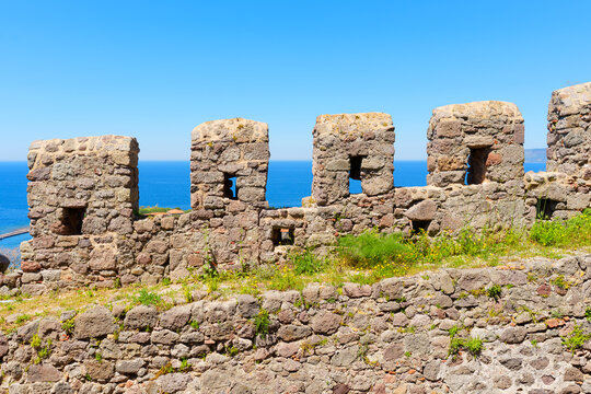 Ancient Stone Battlements of Molyvos Castle Overlooking the Deep Blue Sea